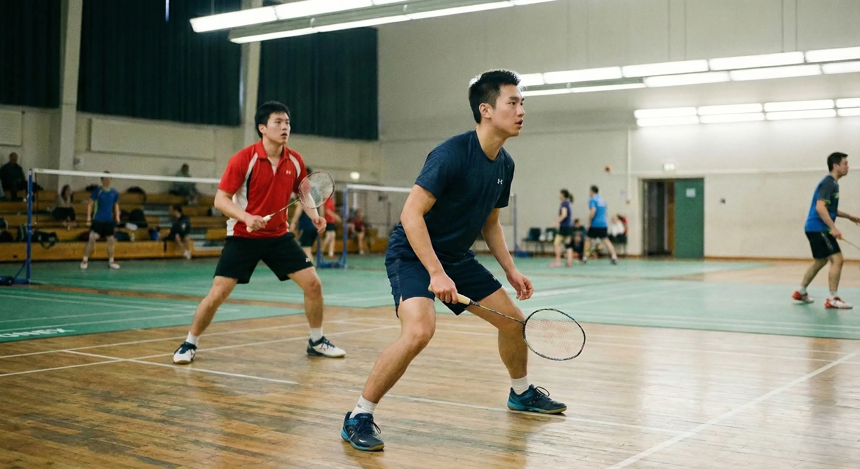 Doubles players in ready position showing calm, balanced stance